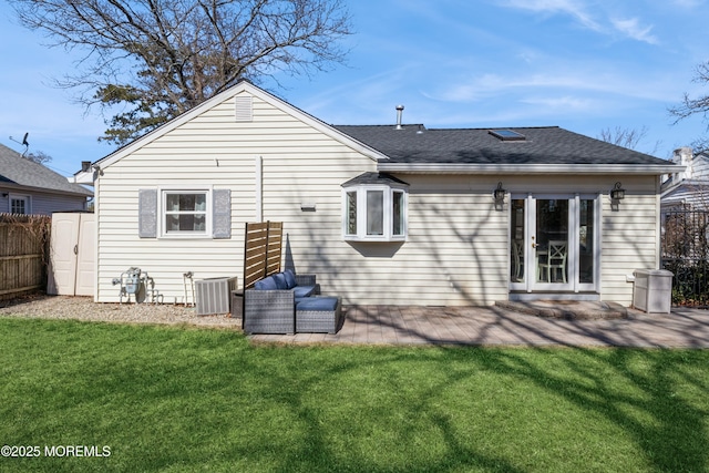 back of house with fence, central AC unit, a lawn, and a patio