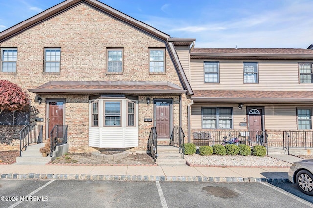 multi unit property with uncovered parking and brick siding