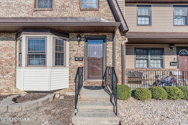 doorway to property with brick siding