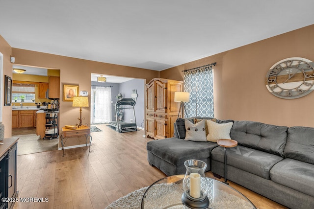 living area with light wood-style floors and baseboards