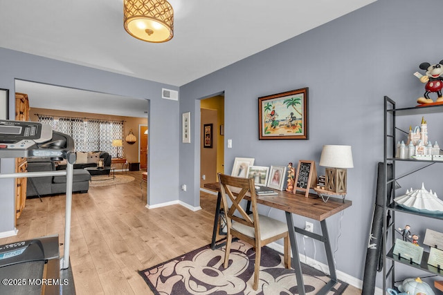 office featuring visible vents, light wood-style flooring, and baseboards