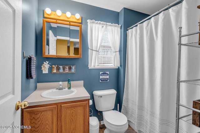 bathroom featuring a shower with shower curtain, vanity, and toilet