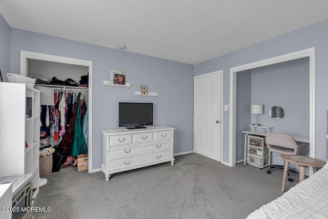 bedroom featuring carpet floors, a walk in closet, a closet, and baseboards