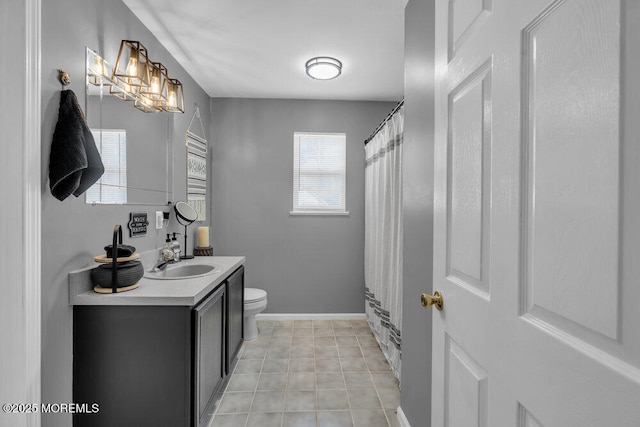 full bathroom with tile patterned floors, vanity, toilet, and baseboards