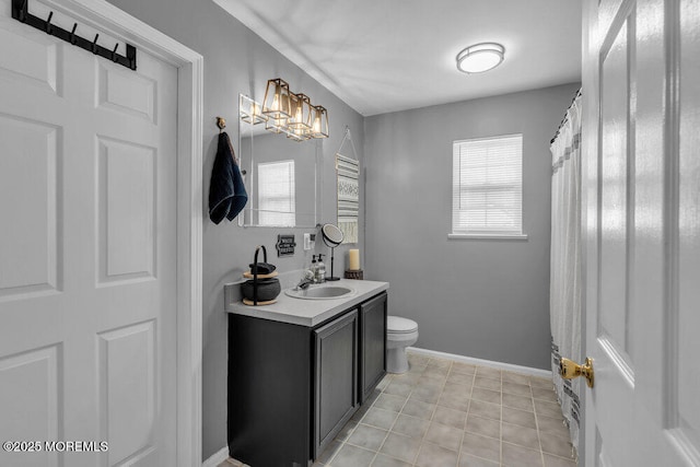 bathroom with tile patterned floors, vanity, toilet, and baseboards