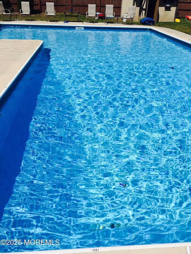 view of swimming pool featuring fence and a fenced in pool