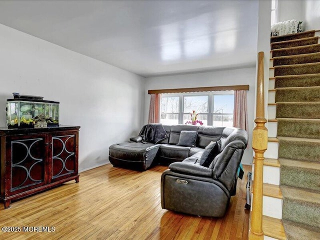 living room with light wood-style floors and stairway