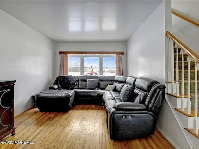 living room featuring stairs and wood-type flooring