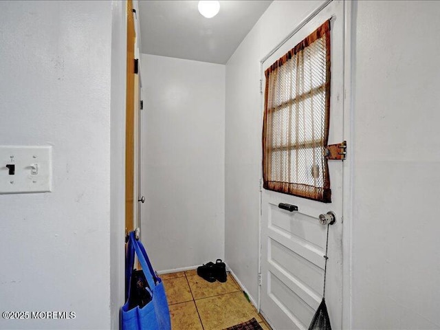 doorway to outside featuring tile patterned floors