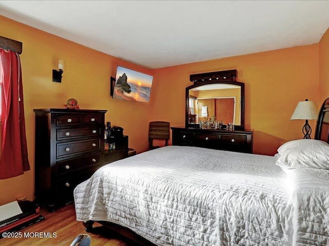 bedroom with wood finished floors