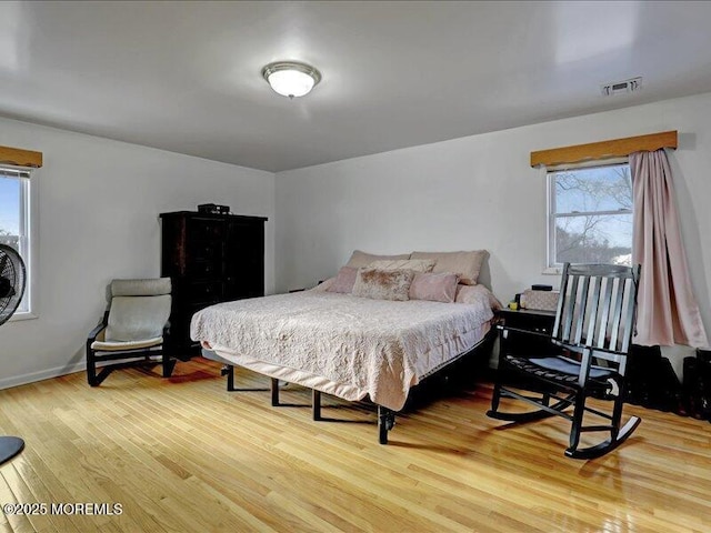 bedroom featuring light wood-style flooring and visible vents