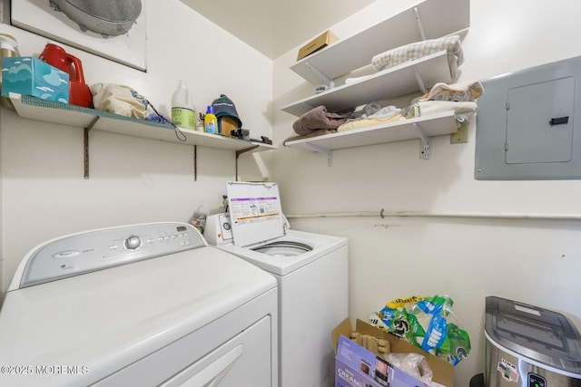 clothes washing area with laundry area, washing machine and dryer, and electric panel