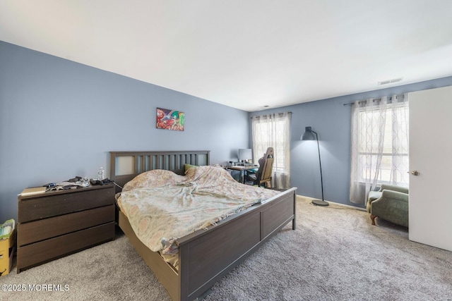 carpeted bedroom featuring visible vents