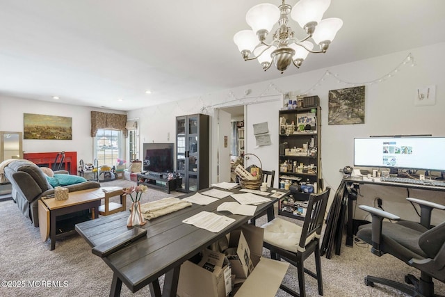 carpeted dining space featuring recessed lighting and a notable chandelier