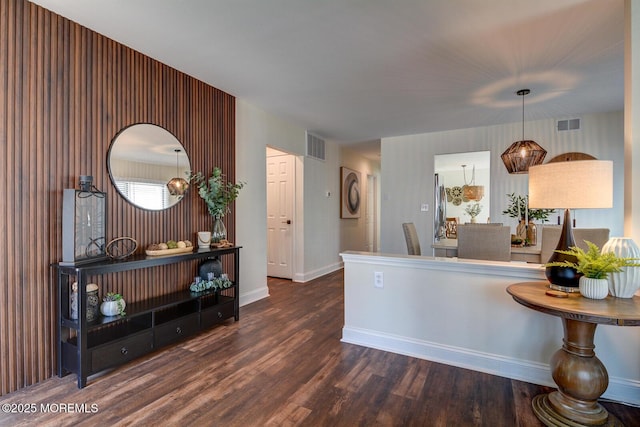 kitchen featuring visible vents, baseboards, and wood finished floors