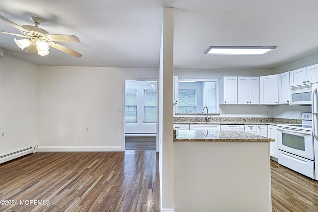 kitchen with dark wood-style floors, light stone counters, white cabinets, a sink, and white appliances