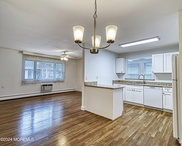 kitchen featuring white appliances, white cabinetry, dark wood-style flooring, and a healthy amount of sunlight