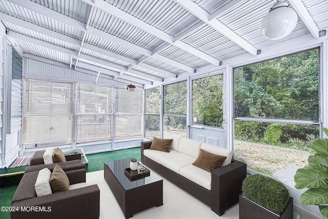 sunroom featuring beam ceiling