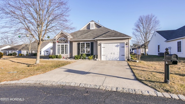 view of front of home featuring driveway, an attached garage, and a front yard