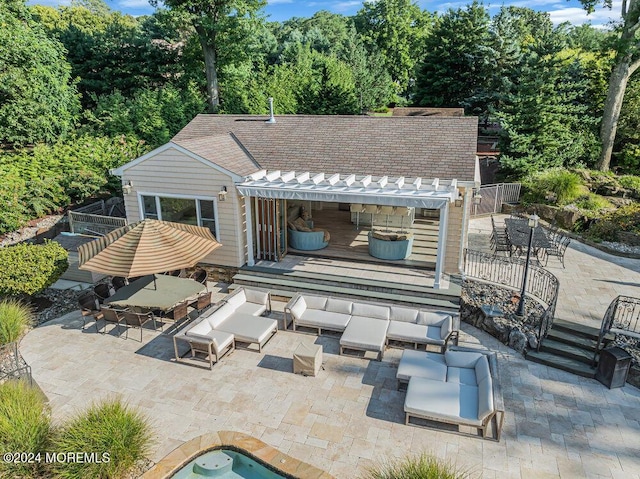 back of house with a patio, outdoor lounge area, and fence