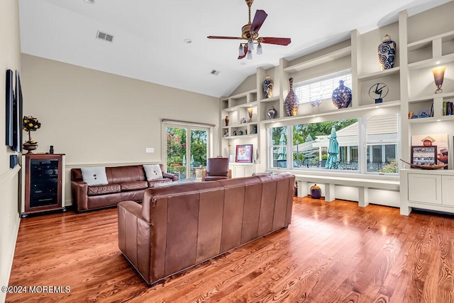 living area featuring a healthy amount of sunlight, light wood-style flooring, and visible vents