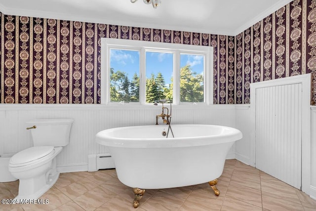 full bathroom featuring wallpapered walls, toilet, a wainscoted wall, a baseboard radiator, and a soaking tub