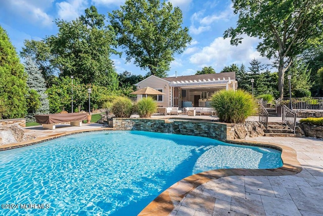 pool with a patio and a pergola