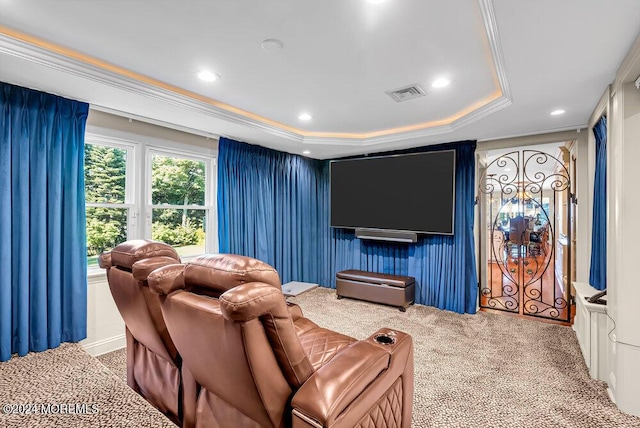 cinema room with a tray ceiling, carpet, recessed lighting, visible vents, and ornamental molding