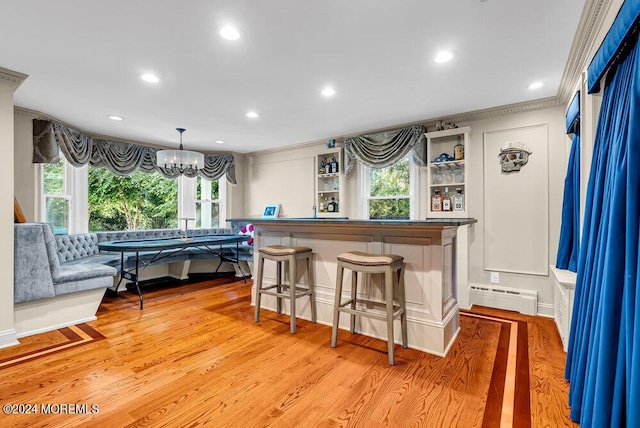 bar featuring light wood finished floors, a baseboard radiator, recessed lighting, and a notable chandelier