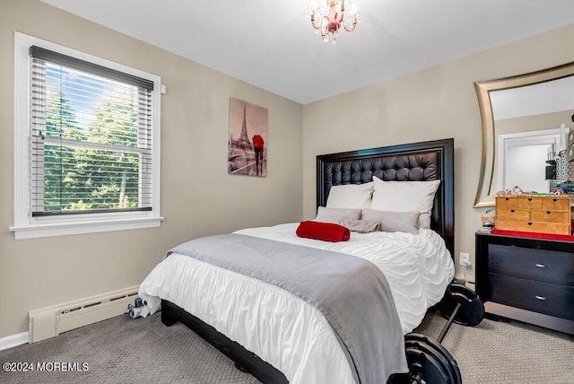 carpeted bedroom featuring a baseboard heating unit, a notable chandelier, and baseboards