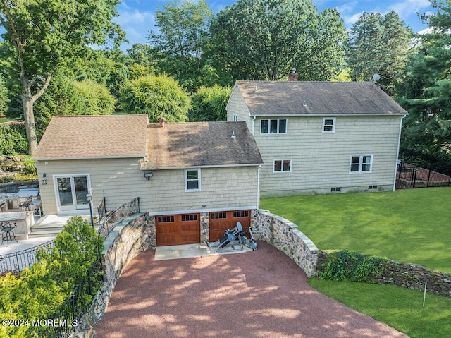 rear view of property featuring roof with shingles, a lawn, a chimney, and fence