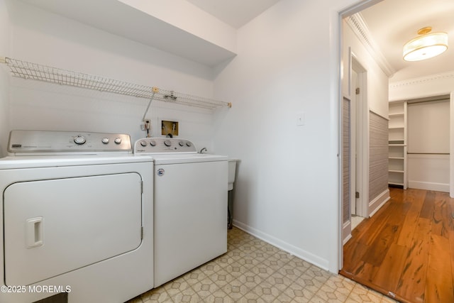 laundry area with laundry area, baseboards, light floors, and independent washer and dryer