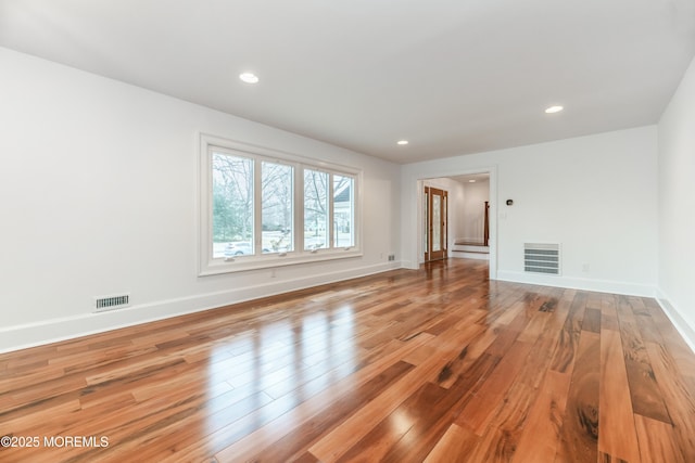 interior space featuring wood finished floors, visible vents, and baseboards