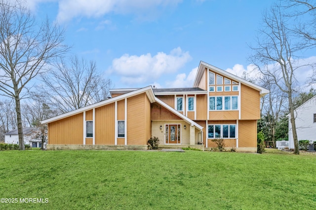 rear view of house with a lawn