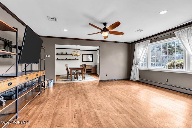 living room with a baseboard radiator, visible vents, wood finished floors, and ornamental molding