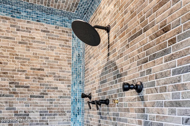 interior details with a tile shower