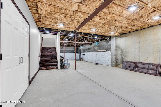 unfinished basement featuring stairway