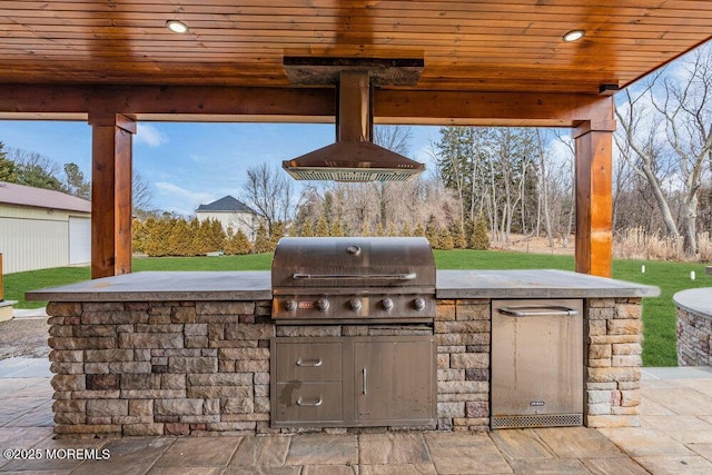 view of patio featuring a grill and an outdoor kitchen