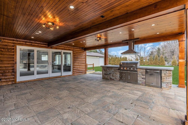 view of patio featuring french doors, area for grilling, and a grill