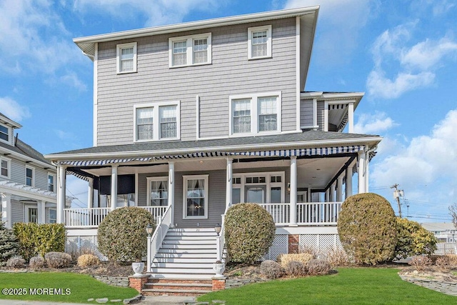 view of front of house featuring covered porch, roof with shingles, and stairway