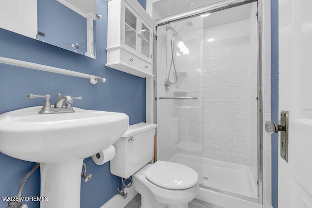 full bath featuring a stall shower and toilet