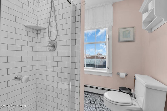 ensuite bathroom featuring toilet, a baseboard radiator, tiled shower, and ensuite bathroom