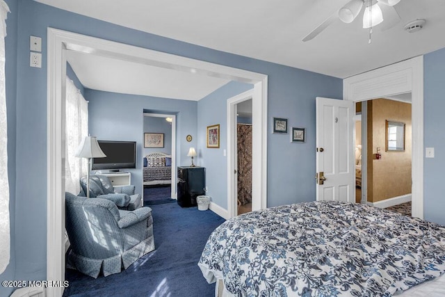 bedroom featuring ceiling fan, multiple windows, baseboards, and dark colored carpet