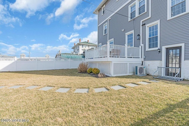 view of yard featuring a deck, ac unit, and fence