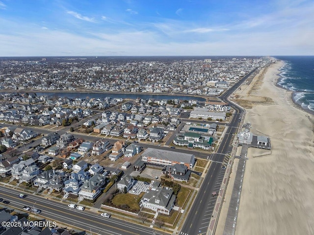 birds eye view of property with a view of the beach and a water view