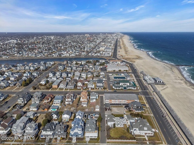 birds eye view of property with a beach view, a residential view, and a water view