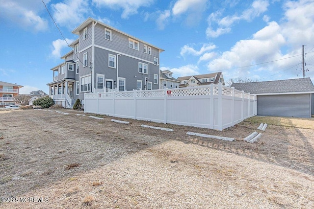 back of house with fence