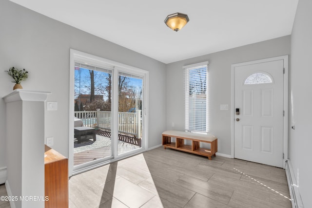 foyer featuring baseboards and a baseboard radiator