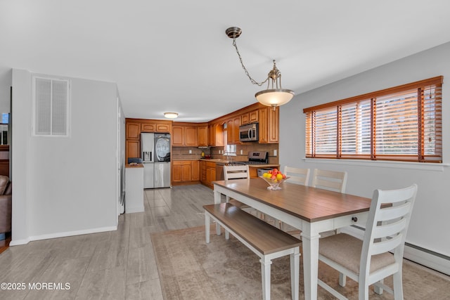 dining room with visible vents and light wood finished floors