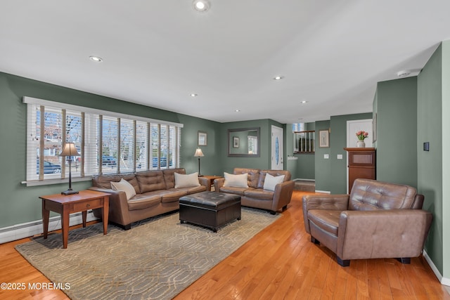 living room featuring recessed lighting, light wood-type flooring, and a baseboard radiator